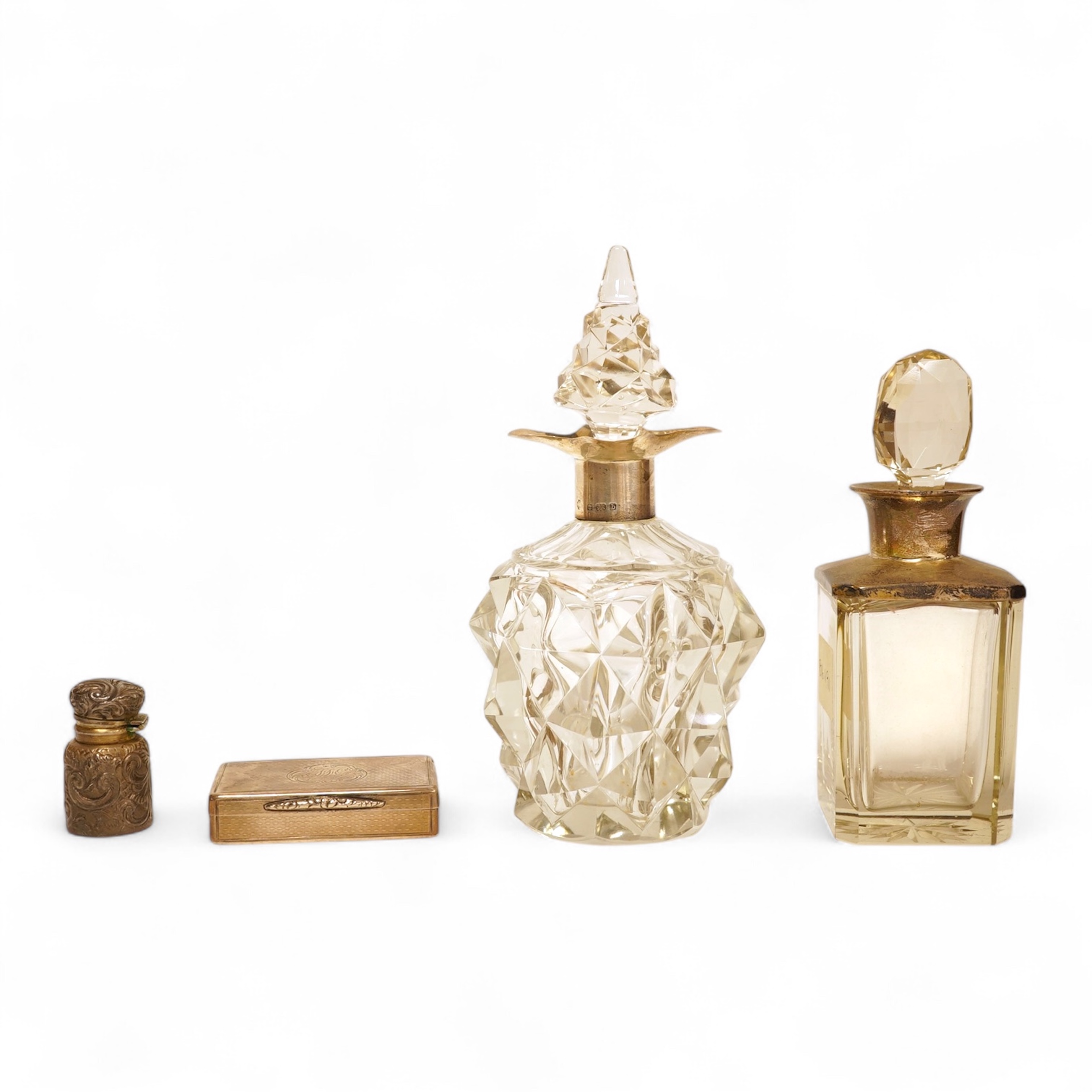 A Victorian engraved silver snuff box, Yapp & Woodward, Birmingham, 1899, 68mm, a small silver scent bottle and two silver-mounted glass scent bottles.
